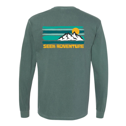 back of a dark teal long tee with decal showing white sharp mountains and lines of mint and teal behind it. beneath it says "seek adventure".